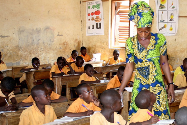 Teacher with class in Ghana